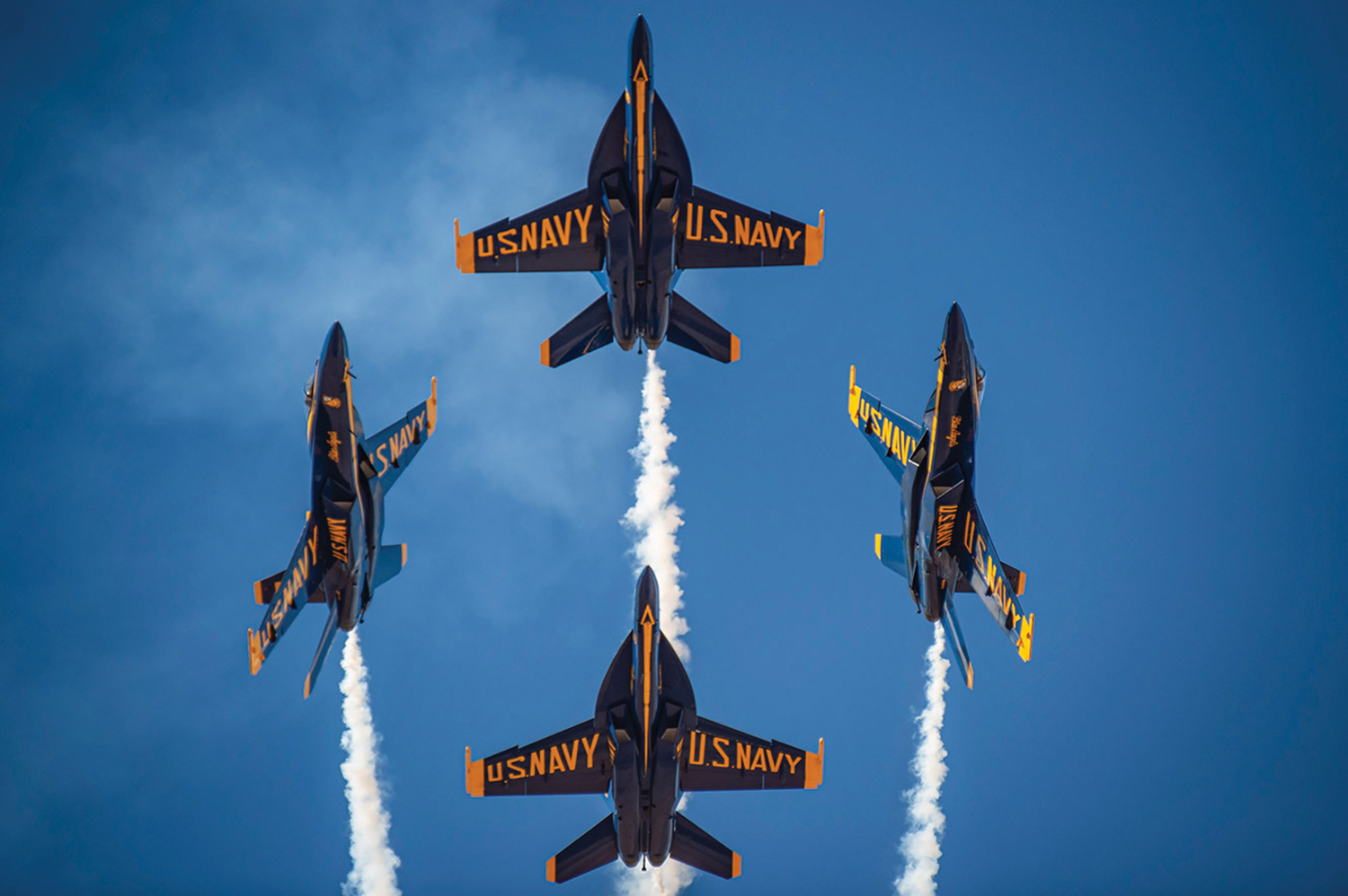 Four Blue Angel jets flying in formation