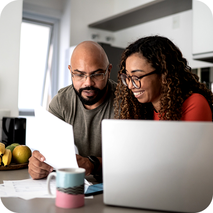Two people at a countertop with a laptop