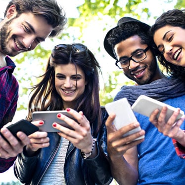 A group of people using their smart phones