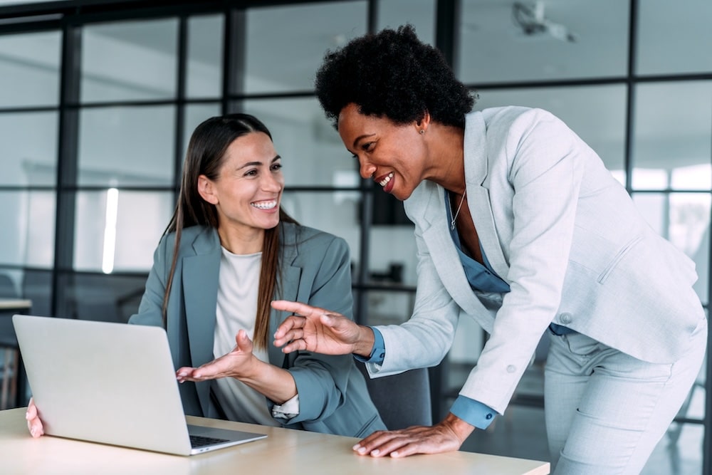 Two people chatting in an office